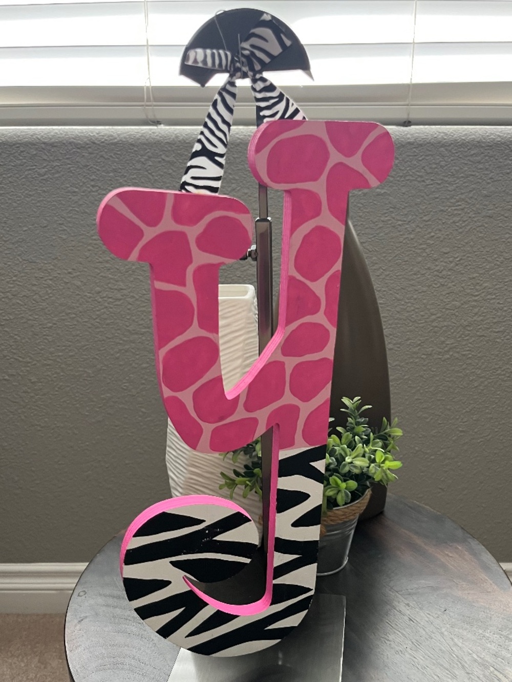 Animal print nursery decor item is a hand-painted wooden wall letter Y